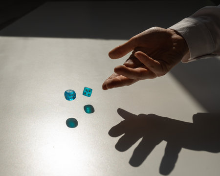 Woman throws a pair of blue transparent dice.の写真素材