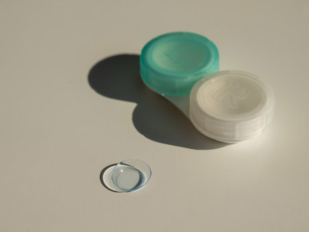 Contact lenses and a storage container on a white table.の写真素材