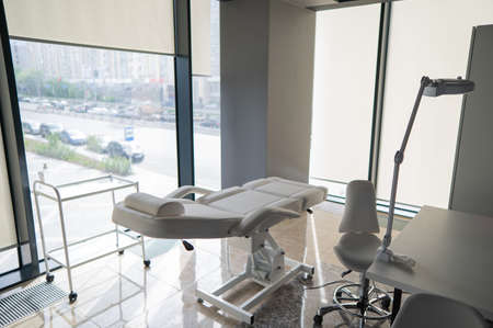 Empty beautician office with white couch and panoramic windows.の写真素材
