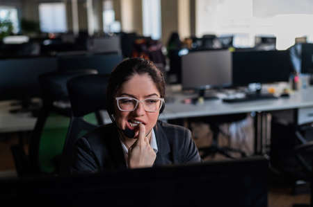 female call center employee biting her nails.