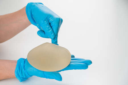 A plastic surgeon shows a breast silicone implant.の写真素材