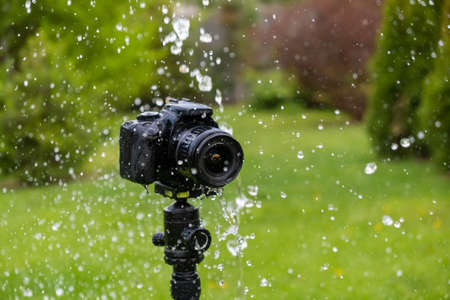 A digital camera on a tripod in the rainの写真素材