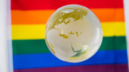 Crystal globe on a rainbow flag. LGBT community.の写真素材