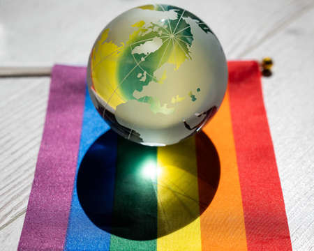 Crystal globe on a rainbow flag. LGBT community.の写真素材