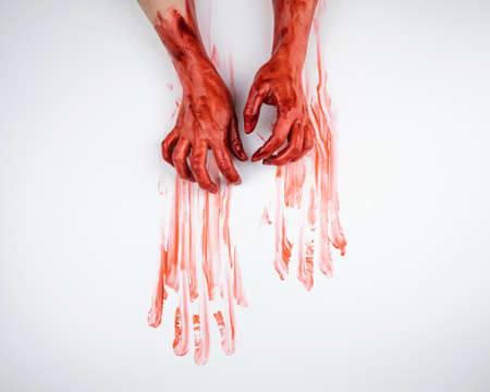 Female hands in blood on a white background.の写真素材