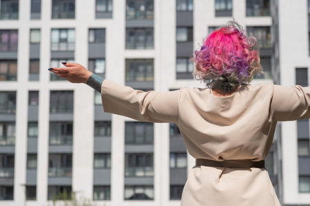 Portrait of a middle-aged woman with multi-colored hair walks on the streets of the city.の写真素材