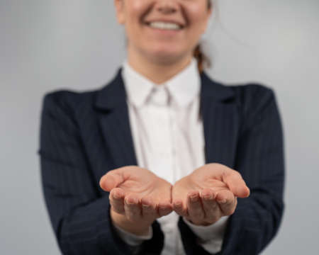 Close-up of caucasian woman holding her palms up.の写真素材
