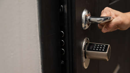 Woman opens the combination lock on the door to the apartment. Keyless entry.