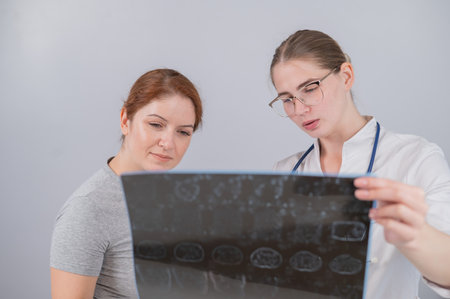 Female doctor explaining mri of internal organs to female patient.の写真素材