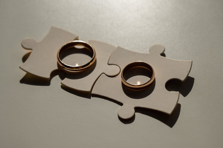 Wedding rings and puzzle pieces. Husband and wife complement each other perfectly.の写真素材