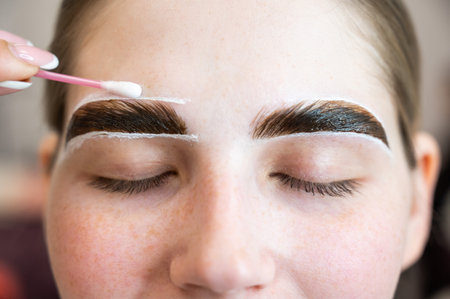 The master paints the eyebrows of a woman.の写真素材