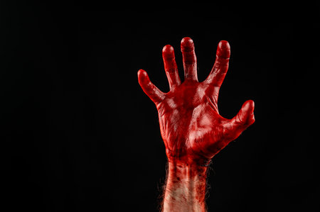 Male palm stained with blood on a black background.