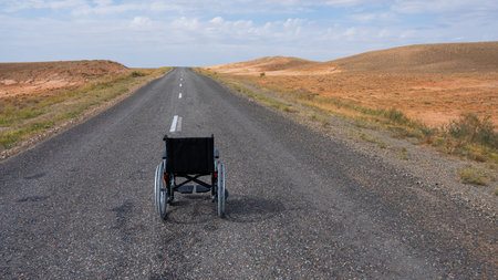 Empty wheelchair on the highway in the steppes.の写真素材