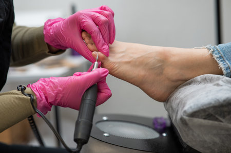 The master makes hardware pedicures to the client. Cuticle treatment.の写真素材