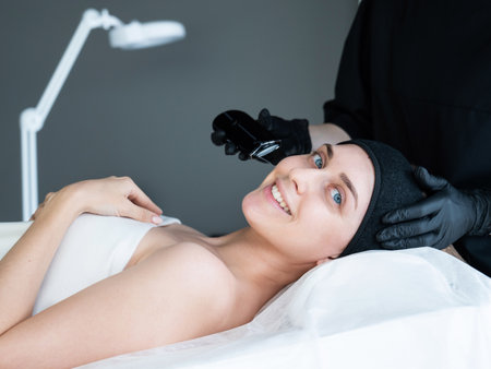 Woman on ultrasonic cleaning procedure. Hardware cosmetology.の写真素材