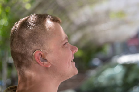 Close-up of a hearing aid on a mans ear.