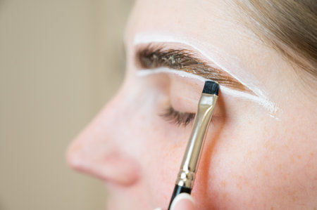 The master draws the shape of the eyebrows with white paint before coloring.の写真素材