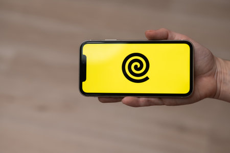 December 3, 2022 Almaty Kazakhstan: Faceless woman holding smartphone with yandex delivery logo.のeditorial素材