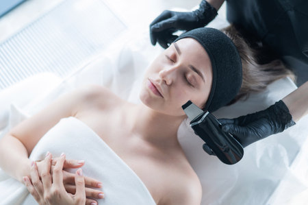 Top view of a woman on an ultrasonic cleaning procedure. Hardware cosmetology.の写真素材