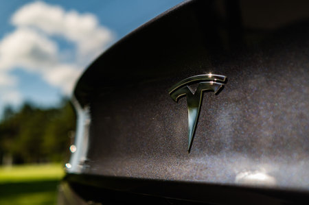 Novosibirsk, Russia - August 10, 2022: Close-up of a Tesla sign on a black car.のeditorial素材