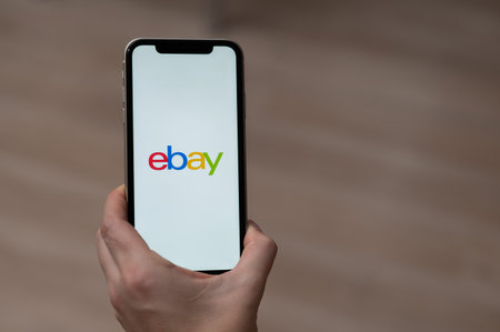 December 3, 2022, Almaty, Kazakhstan: a woman holds a smartphone with an ebay application.のeditorial素材