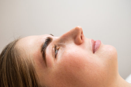 Close-up portrait of a woman after the procedure of correction and lamination of eyebrows.の写真素材