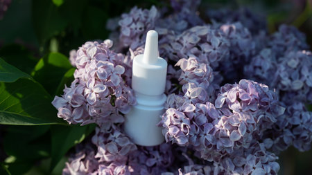 Nasal spray on blooming lilac. Allergy season.の写真素材