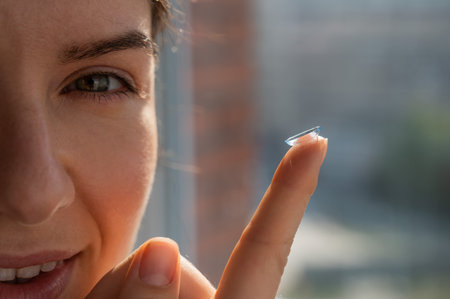 Smiling caucasian woman putting on a contact lens.の写真素材