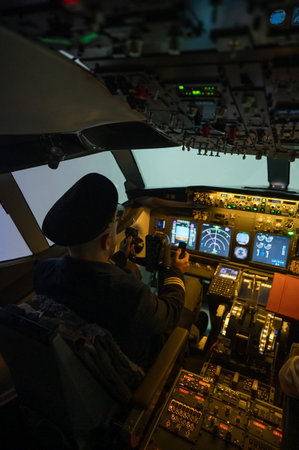 A man is studying to be a pilot in an aircraft simulator.