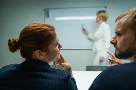 Caucasian woman blonde leads the presentation. Colleagues are having a discussion.の写真素材