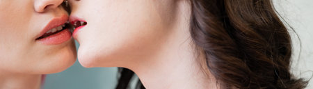 Close-up portrait of kissing Caucasian women. same sex love. Widescreen.の写真素材