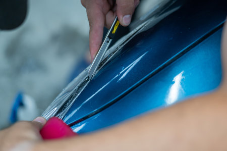 The master in the car service applies an armor film to the car.の写真素材