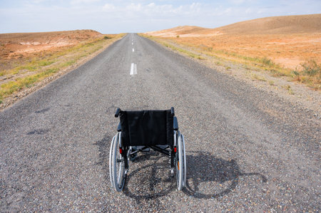 Empty wheelchair on the highway in the steppes.の写真素材