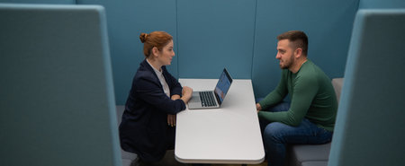 Caucasian woman and bearded man at the talks in the room. Job interview.