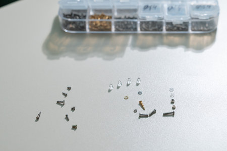 Bolts for repairing eyeglass frames on a white background.