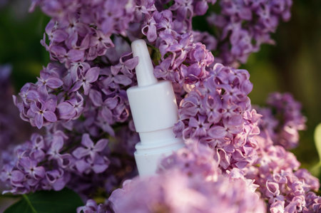Nasal spray on blooming lilac. Allergy season.の写真素材