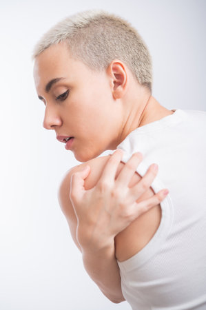 Pretty young woman with a short blond haircut on a white background.