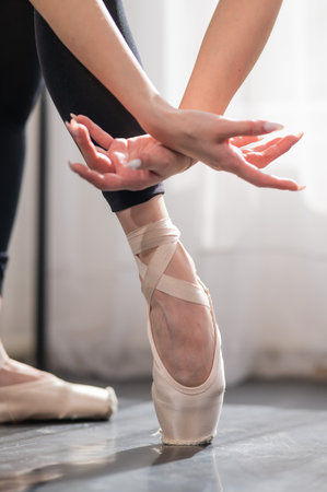 Close-up of the legs and arms of a ballerina.の写真素材