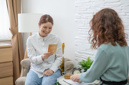 The psychologist uses metaphorical cards in a session with a patient. Caucasian woman tells associations.の写真素材