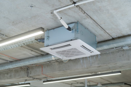 Industrial air conditioner in the office on a concrete ceiling.の写真素材