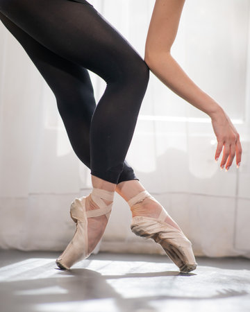 Close-up of the legs and arms of a ballerina.の写真素材