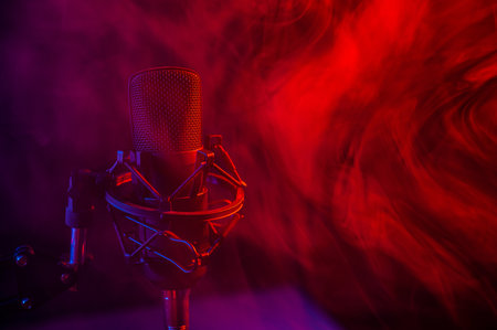 Professional microphone in red blue smoke on a black background.