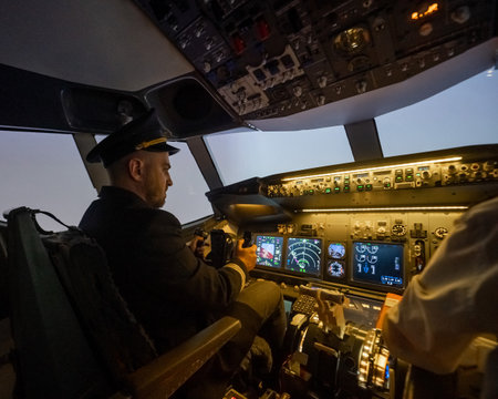 A man is studying to be a pilot in an aircraft simulator.