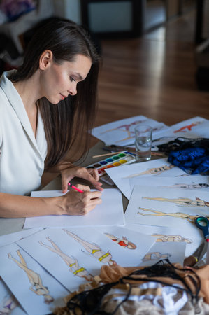 Woman drawing sketches of swimwear and underwear in watercolor.の写真素材