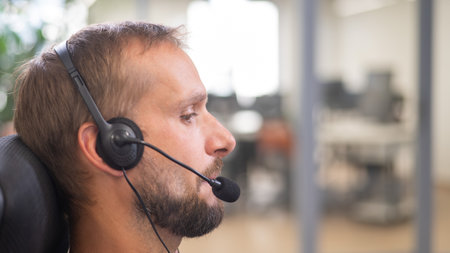 Caucasian bearded man with a headset. Male call center workerの写真素材