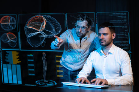Two Caucasian bearded men are discussing medical screen of a virtual menu. Human brain research.の写真素材