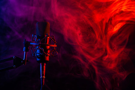 Professional microphone in red blue smoke on a black background.の写真素材