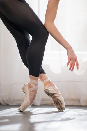 Close-up of the legs and arms of a ballerina.の写真素材