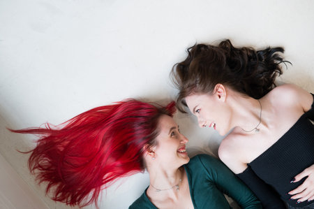 Top view of caucasian women lying and kissing.の写真素材