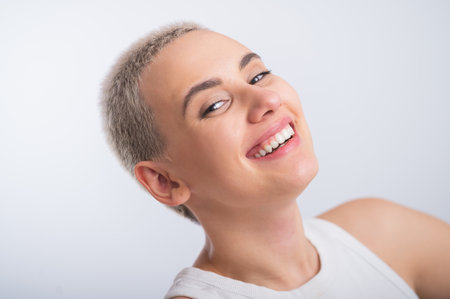 Beautiful young caucasian woman with a short haircut on a white background.の写真素材